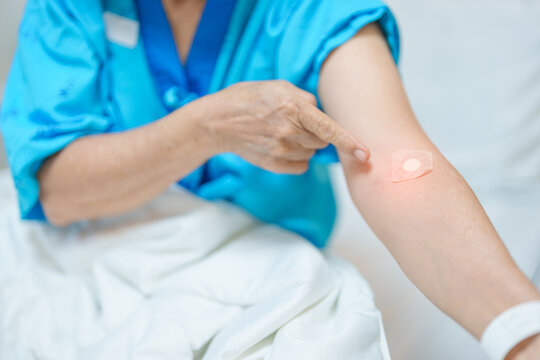 Elderly asian Patient Woman with medical patch plaster after blood test in hospital. Diagnose, illness, treatment, Insurance, Healthcare, medical Examination, Blood donation and World Blood Donor Day