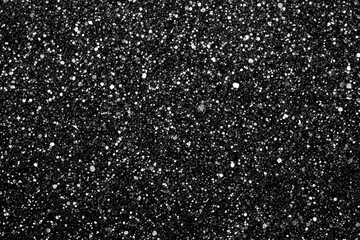Black background with silver glitter. Ideal for adding sparkle to designs, cards, or websites.