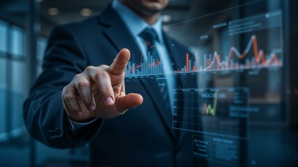 Businessman touching holographic display of graphs and charts.