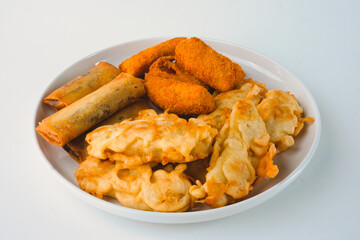 Assorted Fried Snacks Served on a White Plate. Such as Fried banana, Piscok, and Risol mayo