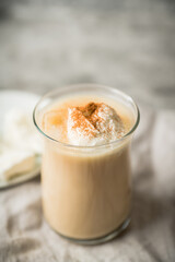 Coffee with ice cream and cinnamon in glass cup. Selective focus.