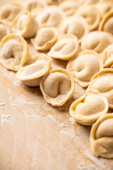 Raw dumplings in flour on the table. Russian national food. Selective focus.