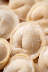 Raw dumplings in flour on the table. Russian national food. Selective focus.