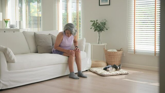 Asia adult people middle age old woman itch leg arm elbow body dry skin hand touch neck stress sad pain sit at home elder health care aging beauty illness issue. Asian female aged mosquito bite itchy.
