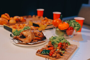 Happy young friends group having lunch at home. Asia family party eating pizza food and laughing enjoying meal while sitting at dining table together at house. Celebration holiday and togetherness.
