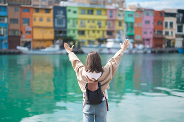 Naklejka premium woman traveler visiting in Taiwan, female Tourist with backpack sightseeing at Keelung, Colorful Zhengbin Fishing Port. Popular landmarks and attractions near Taipei City. Asia Travel concept