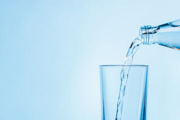 Crystal clear water being poured into a transparent glass, creating refreshing ripples and bubbles