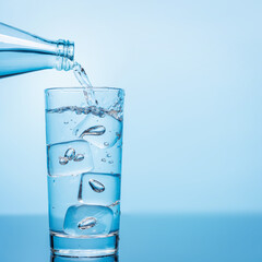 Crystal clear water being poured into a transparent glass, creating refreshing ripples and bubbles