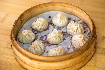 Enjoy the exquisite taste of Steamed Dumplings in a Bamboo Steamer, a delight of Asian Cuisine