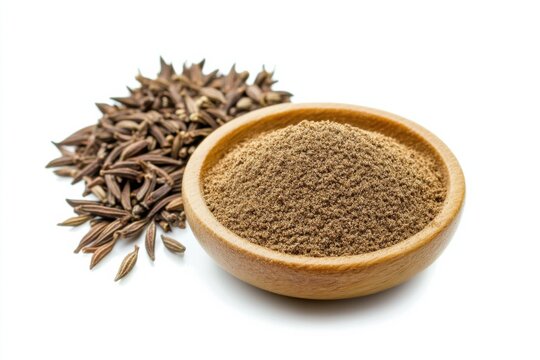 High quality ground cumin spice in wooden bowl with whole cumin seeds on clean white background