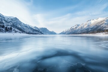 Frozen beauty a scenic view of a frozen lake surrounded by snowy mountains in a majestic winter landscape under a clear blue sky