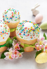 Easter cakes decorated with colorful sprinkles and spring flowers