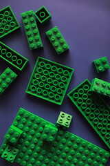 A scattering of constructor elements for children. Colored bricks from the puzzle.