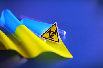 Ukrainian flag biohazard and test tubes. Assistance to Ukraine in biolaboratories. Western...