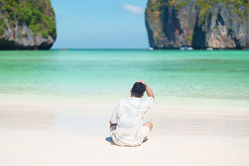 man tourist traveling and sightseeing in Krabi, Thailand, happy traveller enjoy at Maya Bay beach...