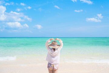 Happy Woman tourist with hat relaxing and enjoying on beach, young solo traveller looking beautiful...