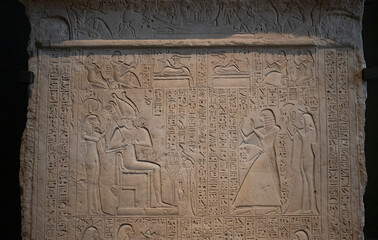 ancient Egyptian carvings and hieroglyphs on sand stones at the Grand Egyptian Museum in Cairo, Egypt