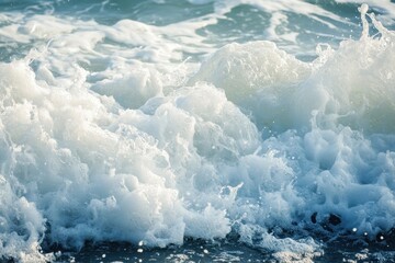 Fototapeta premium Ocean waves with foam rolling in, creating a serene and powerful coastal scene