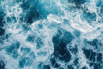 Fototapeta premium Foamy waves rolling up the shore, capturing the essence of the ocean's ebb and flow