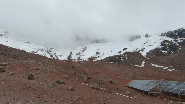 Base of Chimborazo mountain volcano snow fog covered Ecuador nature landscape, refuge solar panels