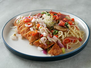 Pasta spaghetti aglio o lio with fried chicken on white plate