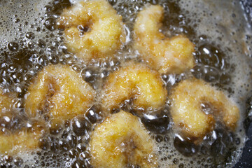 
it is  cooking shrimp tempura.
