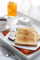 toast with jam white plate hot tea english breakfast