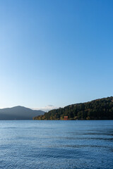 Fototapeta premium Mt. Fuji and red Torii gate on lake Ashi at Sunset, Hakone, Japan