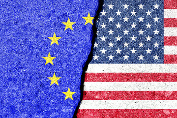 The crack between the flags of the United States and the European Union. The concept of problems in...