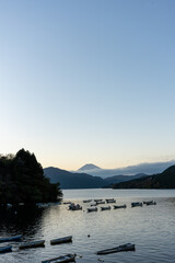 Mt. Fuji and small boats on lake Ashi at Sunset, Hakone, Japan
