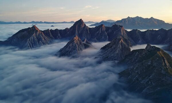 A drone perspective reveals the stunning mountainous terrain shrouded in morning fog, highlighting the illustrious Huangshan National Park in China