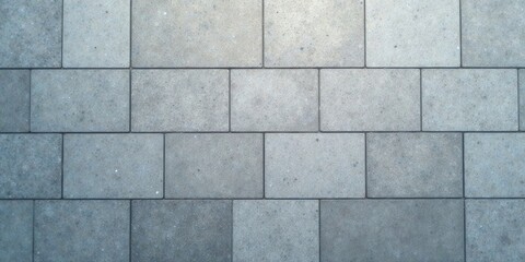 Naklejka premium Overhead View of a Smooth, Gray Stone Pavement Composed of Uniform Square Tiles Showing Subtle Variations in Tone and Texture