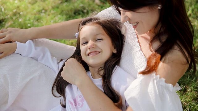 A heartfelt depiction of a mother and daughter enjoying quality time outdoors in a warm, intimate bond that reflects joy and togetherness