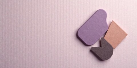 Abstract shapes on a textured background, showcasing a minimalist design aesthetic with muted pastel tones and subtle shadows adding depth