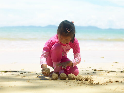 little girl playing on the beach