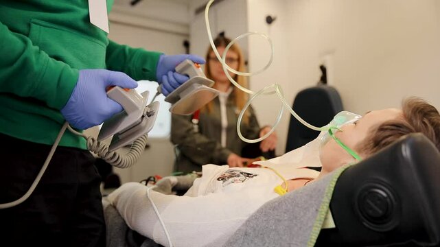Emergency medical situation showing a professional using a defibrillator on a patient during lifesaving practice