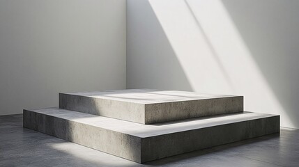Fototapeta premium Two tiered concrete platforms inside a minimalist white room
