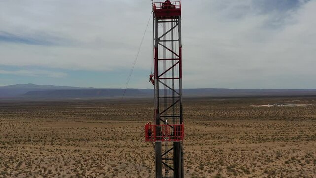 A worker climbs the side of a fracking drilling rig in Vaca Muerta.Tratayen, Loma Campana, La Amarga Chica, Bajada del Palo Oeste, Mata Mora Norte, Bosque Cha&ntilde;ar, Loma Colorada. Auca Mahuida Neuqu&eacute;n