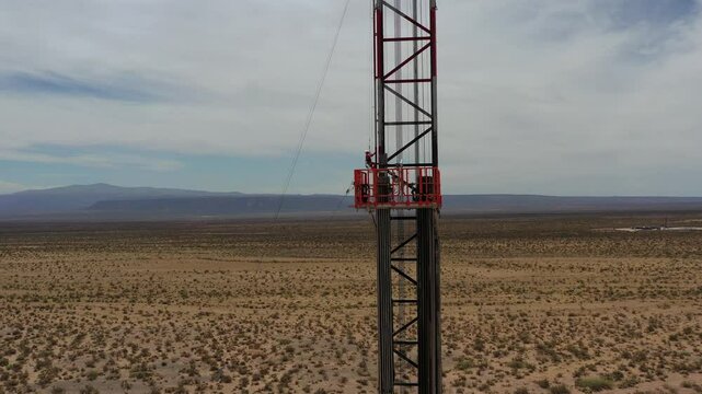An oil worker climbs the side of a fracking drilling rig in Vaca Muerta.Tratayen, Loma Campana, La Amarga Chica, Bajada del Palo Oeste, Mata Mora Norte, Bosque Cha&ntilde;ar, Loma Colorada. Auca Mahuida