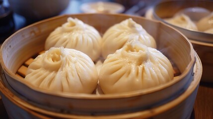 A close-up view of delicious baozi is shown. The baozi, with their soft and fluffy dough skins, come in various fillings, such as savory minced meat, flavorful vegetables, or a combination of both. 