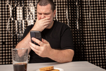 Shocked man with smartphone, astonishment at reading unexpected news, emotional facial expression...