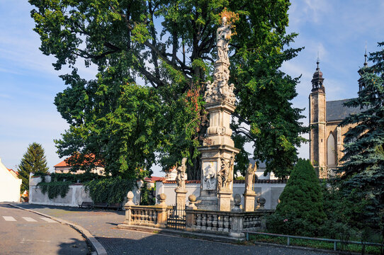 Majestic plague column near famous Sedlec Ossuary stands tall in Kutna Hora, Czech Republic, narrating tales of resilience and faith against a backdrop of historical architecture