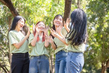Smiling women team showing dirty hands outdoors, Cheerful young Asian multigenerational group enjoying outdoor teamwork