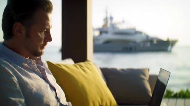 Remote working professional on yacht, caucasian man using laptop on luxury boat deck, digital nomad lifestyle near marina, coastal business success