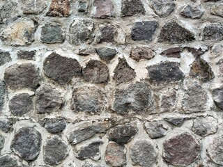 Surface texture on the wall made of mountain stone.