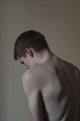 A shirtless young man poses against a plain white background, ready for action