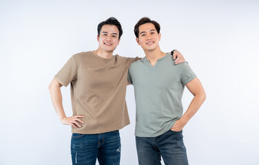 Two smiling men pose together with arm around each other. They are casual and happy on white...