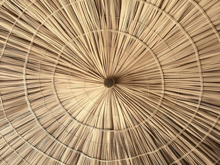 Dry straw roof covering creating concentric circles with central binding