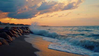 Dramatic sunset over ocean waves crashing on a rocky beach