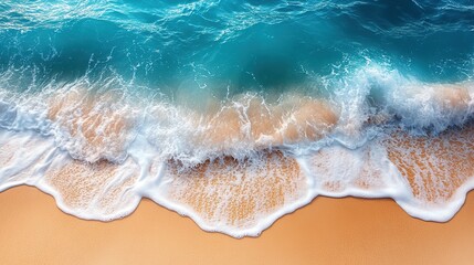 Obraz premium Turquoise waves meet gold sand, a calming color and texture contrast.